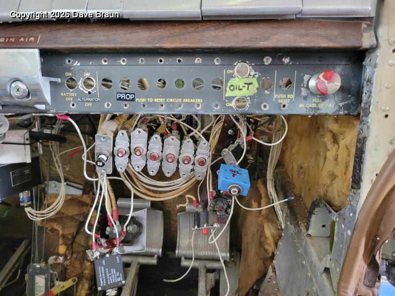 2024-03-06 15.51.51.jpg - The old push to reset circuit breakers, most non-pullable, with many more thermal circuit breakers spread around the glove box.