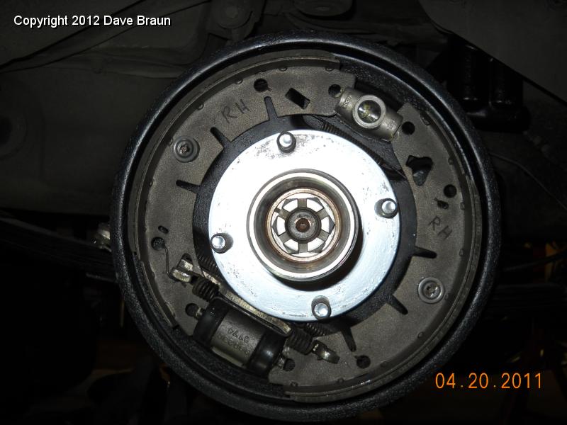 Rear Brakes revised RH 03.jpg - I wasn't real happy about the workshop manual's procedure or spring indentification. I started to search the web, and John Twist recommends this arrangement. Note that holes for the two main springs, and the orientation of the spring tab into the parking brake lever.