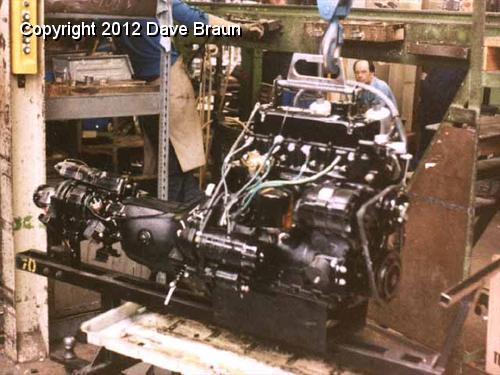 How the factory did it 0.jpg - This shows an 18V engine at the factory ready to go in. Note the butterfly mount is on the gearbox. After the engine is placed on the mounts, the rear crossmember will be levered on against the rear mount rubbers.