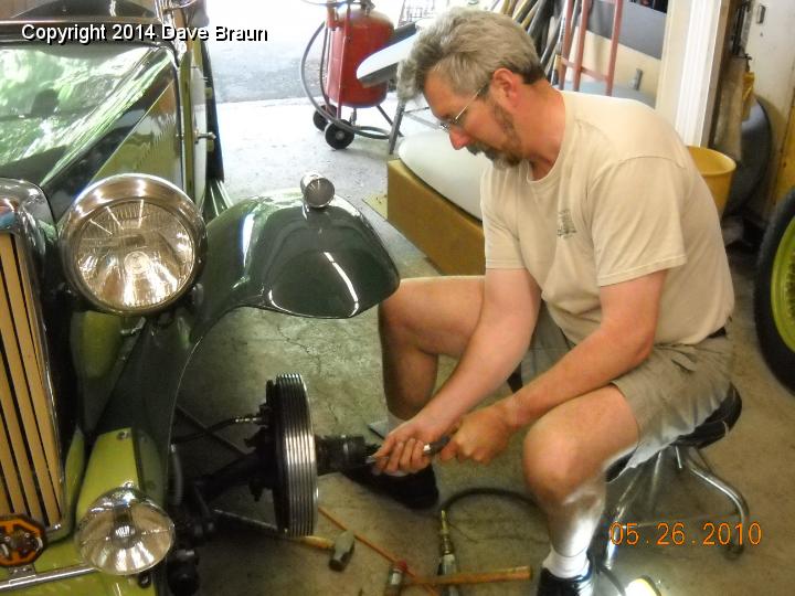 Replacing drum.jpg - We removed the alfin drum to provide clearance to distort the steering arm with two sledges. Here I am, re-installing the drum.