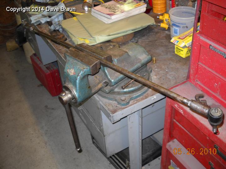 Tie Rod on Bench.jpg - Tie rod in the vise being adjusted. Ended up using trial and error since we couldn't turn the tie rod on the car. The final adjustment was 1/4 turn each.
