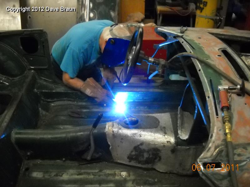 Welding up seat attach points in floor 05.jpg - Mike is welding in the plate with the new seat rail nut on it.