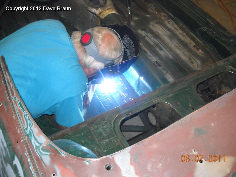 Welding up seat attach points in floor 06.jpg - Here he is filling in the cracks around the nuts.