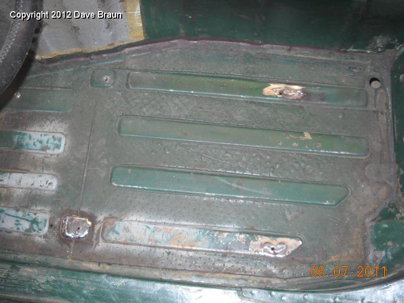 Welding up seat attach points in floor 09.jpg - Welds ground down.