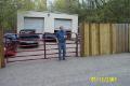 Brian in front of gate to new shop